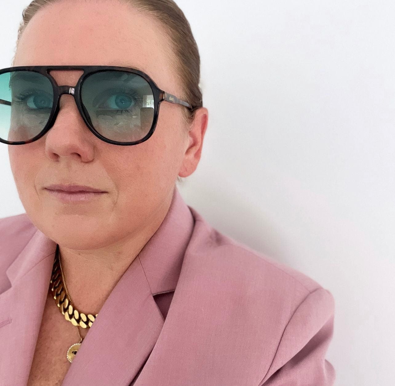 Rhodin Our Story - Alex in sunglasses  - Produces a range of quality sunglasses, jewellery and resort wear that combine classic style with a modern coastal chic. We design pieces to holiday in.